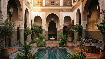 Moroccan riad courtyard with zellige tilework and arches