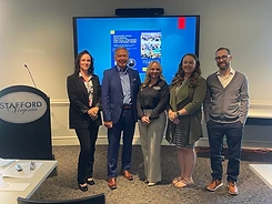 Kirstin Purcell with fellow speakers in front of a Managing Poor Performers workshop slide in Stafford, Virginia