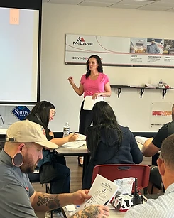 Kirstin Purcell leading a training session with a room full of participants