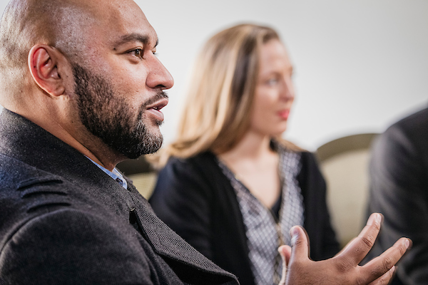 A leader gesturing during a collaborative workshop discussion