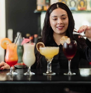 Bartender crafting cocktails at the Kasa Amigos bar