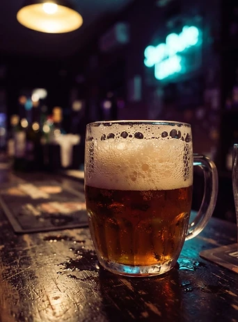 Craft beer foam under warm yellow light