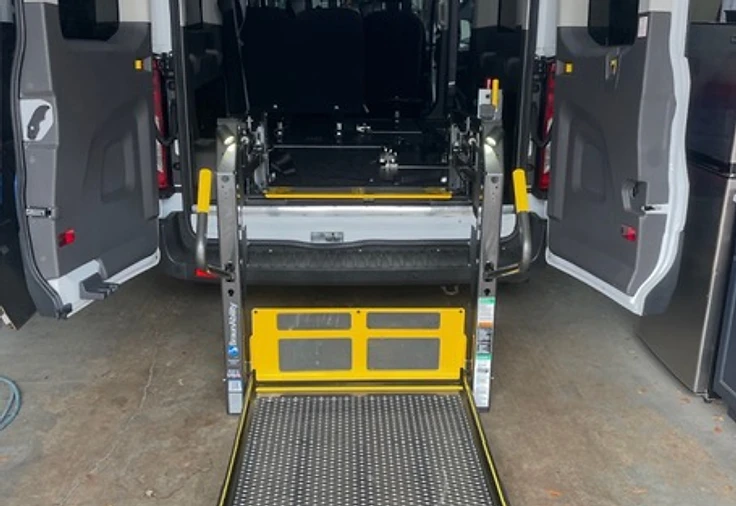 Rear-entry wheelchair lift deployed from a commercial van