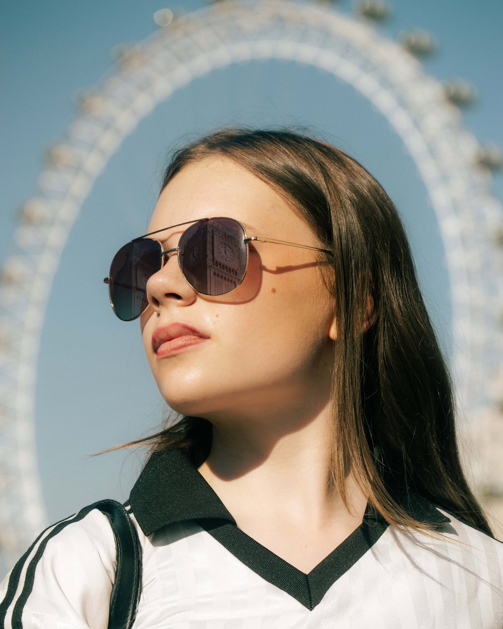 Fan in golden-hour light framed by the London Eye