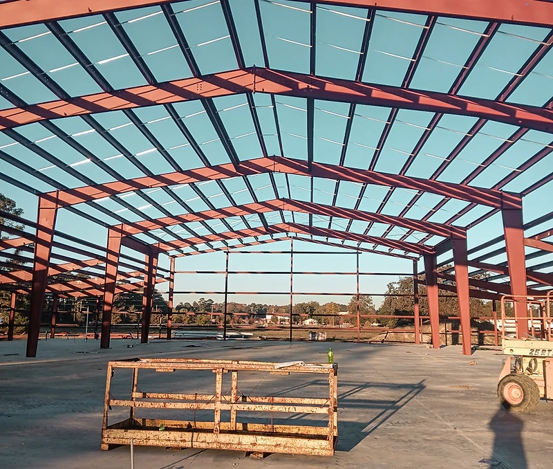 Structural steel frame of a building under construction at golden hour