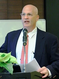 Daniel B. Schwartz speaking at a podium