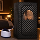 Ayanity Restore portable steam sauna set up beside a bed in a dim bedroom
