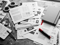 Design studio desk with typography and brand identity print-outs