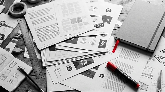 Design studio desk with brand identity print-outs