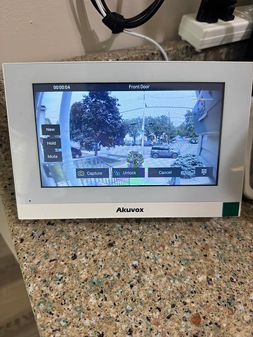 Akuvox smart video intercom panel displaying a live front-door camera feed