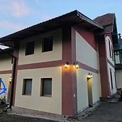 Villa Klein — exterior at twilight, rear view with illuminated vintage lanterns