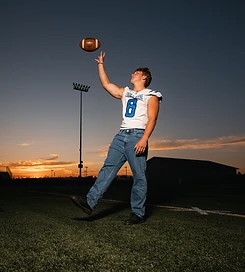 Senior football portrait at sunset