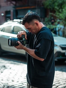 Elijah behind the camera on a street shoot