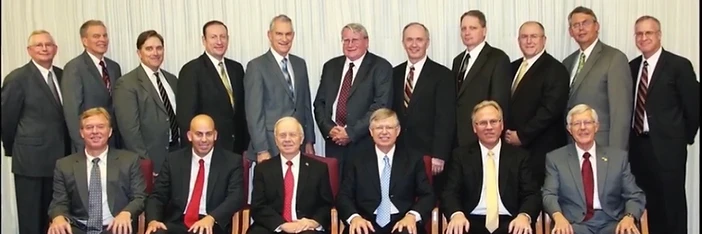 Dennis with a group of men in formal attire