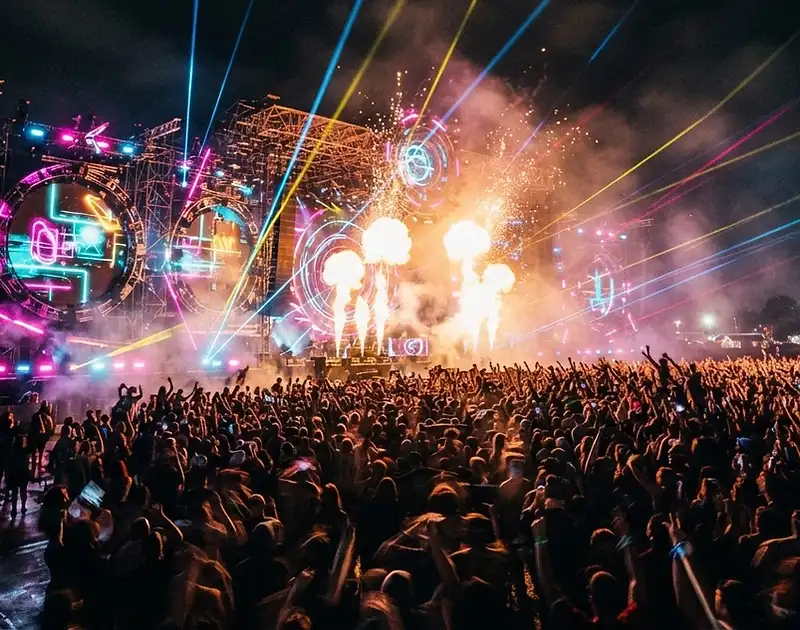 Massive EDM festival crowd at the peak drop, lasers and lights
