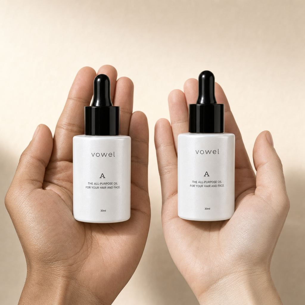 Two hands each holding a vowel A oil bottle