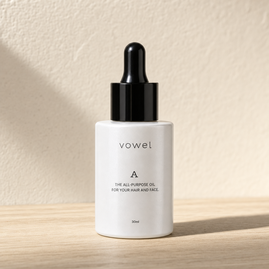 The vowel A bottle on a light wooden surface against a textured beige wall
