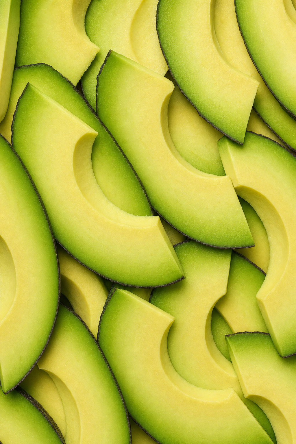 Sliced avocado, showing pale flesh and green skin