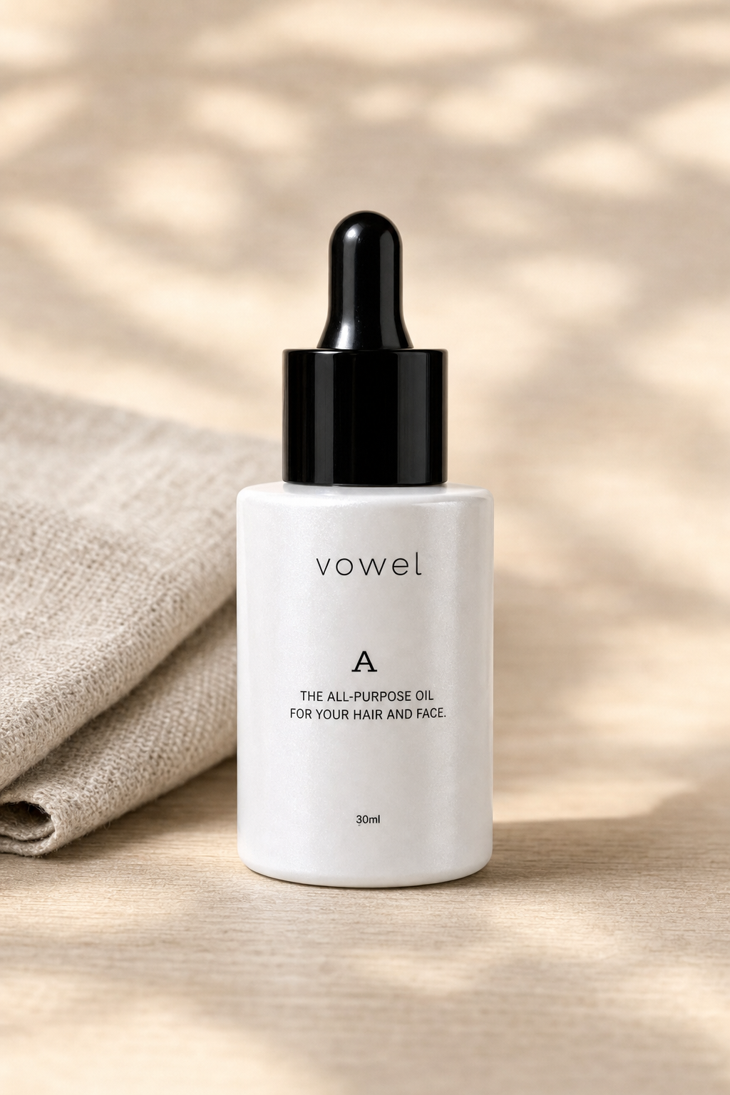 vowel A oil bottle on a wood surface with dappled light