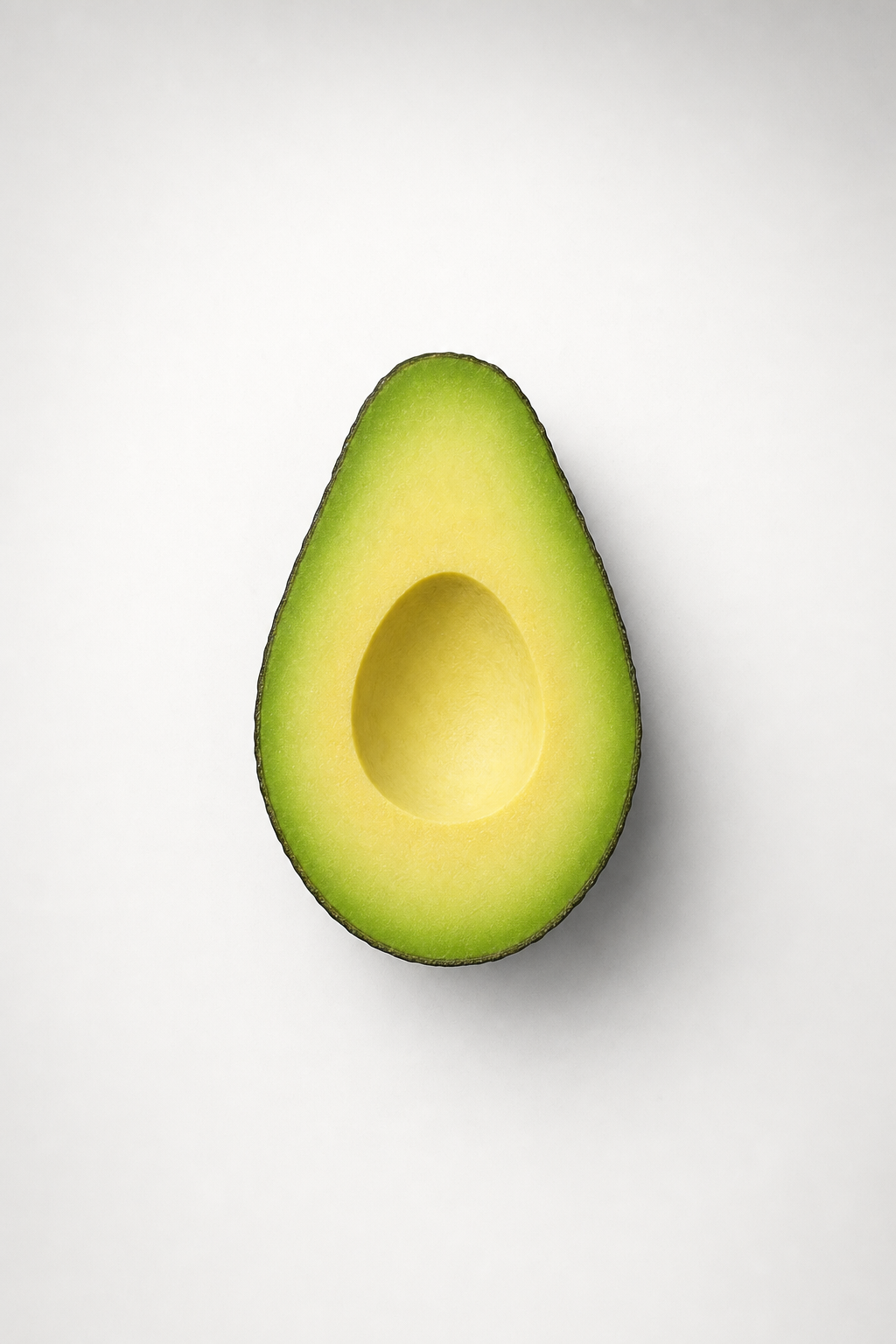 A single halved avocado with the pit removed against an off-white background