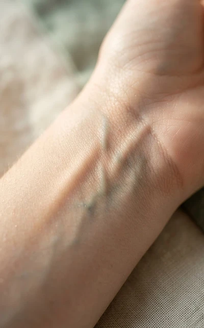 Macro close-up of a human wrist pulse point in soft morning light
