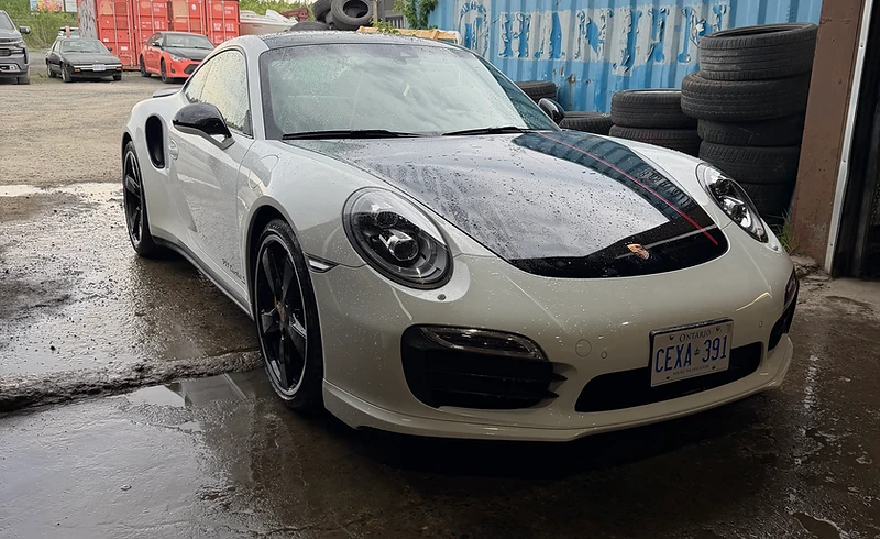 White Porsche parked at Moonglo Auto Repair