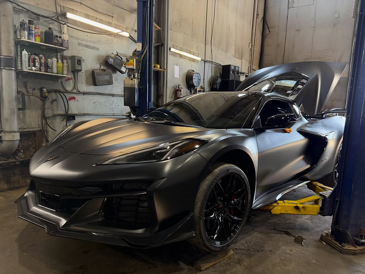 Custom Corvette C8 on the lift at Moonglo Auto Repair