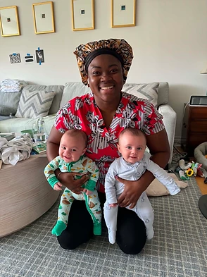 Devon holding newborn twins during a home visit