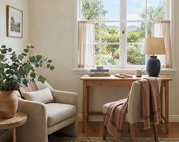 A quiet writer's corner with a slim wooden desk near a window