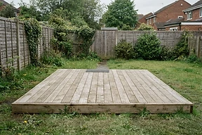 Basic low ground-level deck in a small backyard