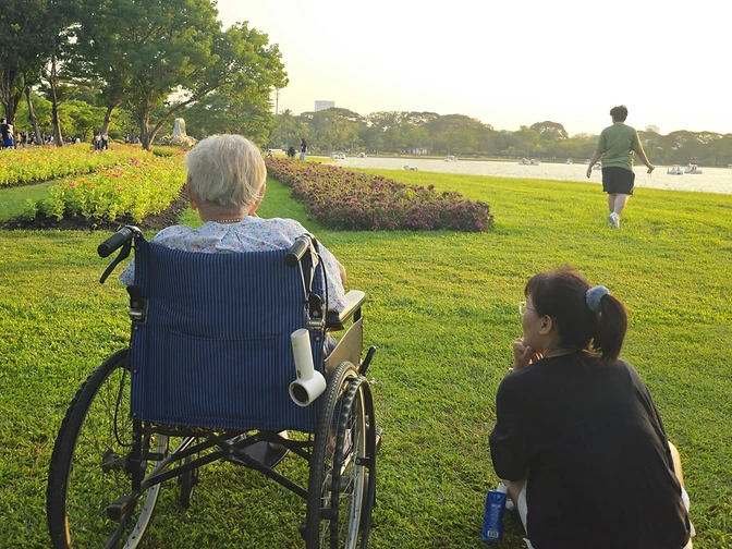 A companion and member enjoying a golden-hour park outing together