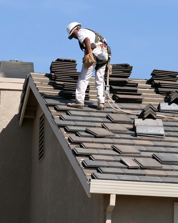 Outlaws Roofing crew installing a roof backed by long-term warranty protection