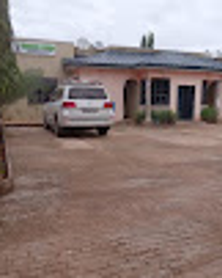 Sinsaba Lodge courtyard behind a secure gated entrance in Gumani, Tamale