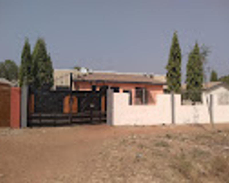 Sinsaba Lodge exterior at golden hour against the Tamale savanna horizon