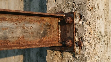 Architectural detail of a steel beam meeting a concrete wall