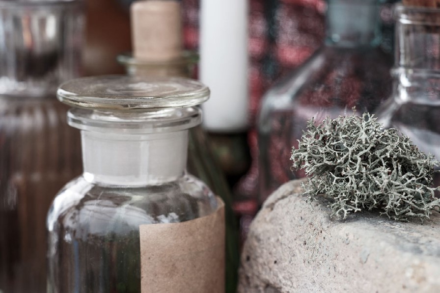 Atmospheric apothecary still life: antique glass bottles, dried herbs, moss and natural textures — original Once Upon a Time imagery by Helena B. Scott