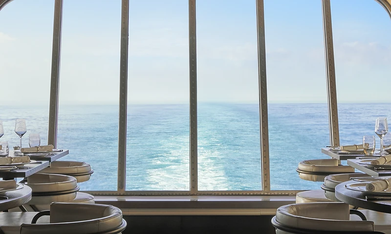 An ocean view through a panoramic window aboard a Virgin Voyages ship