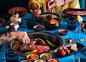 A Korean BBQ grill at a communal table aboard the ship