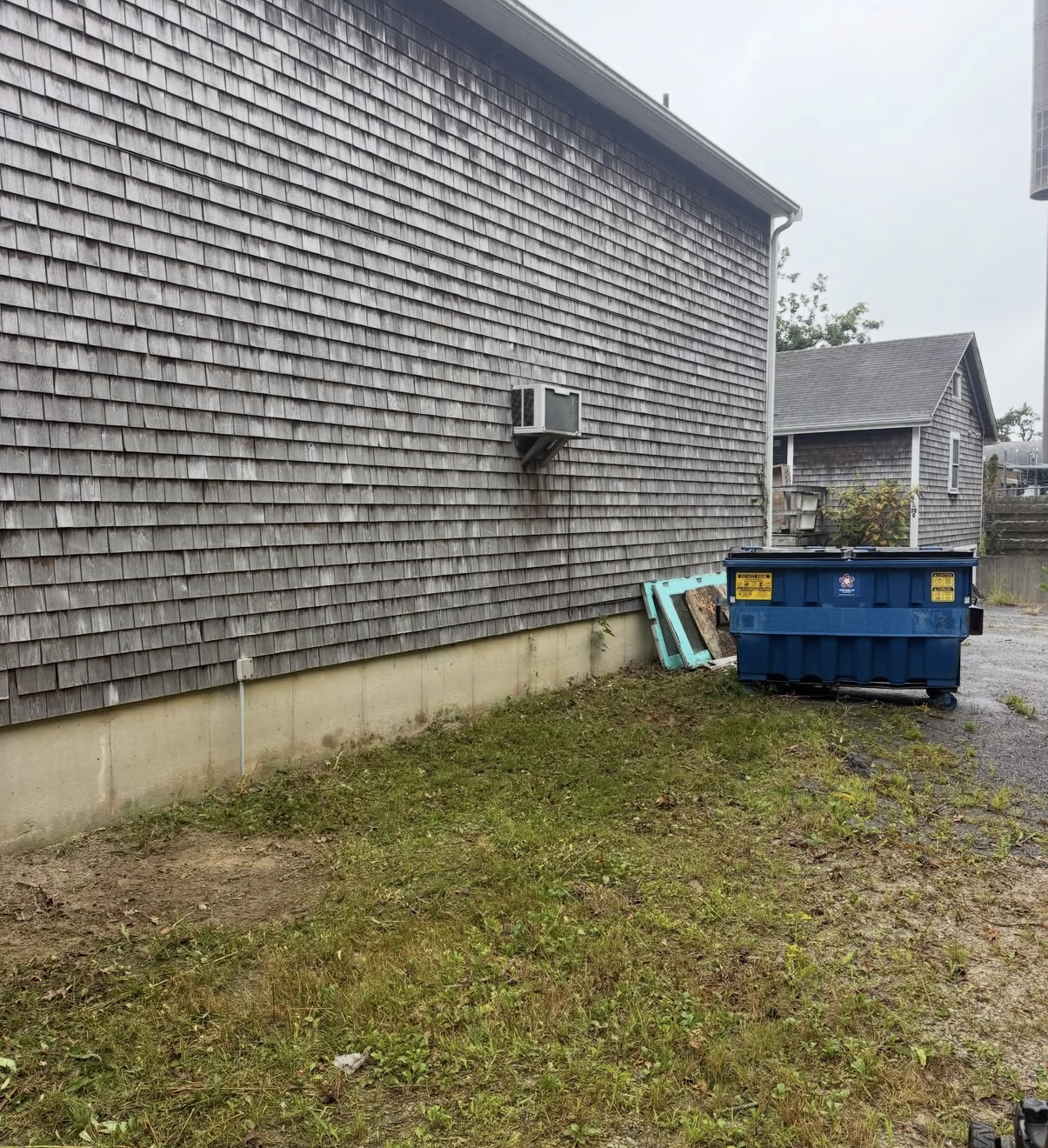 After building-side overgrowth removal — property cleanup results