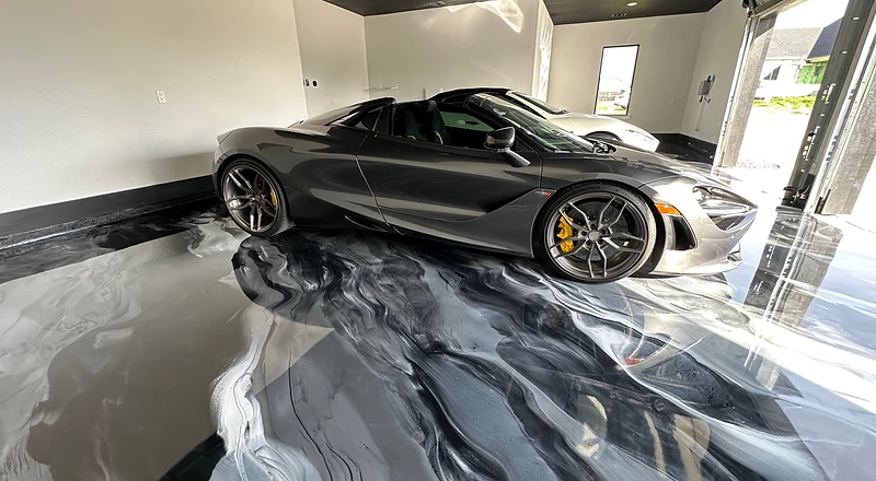 McLaren on a wet-look metallic epoxy showroom garage floor