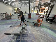Sanding and detail work in progress on the metallic epoxy floor with HEPA vacuum extraction