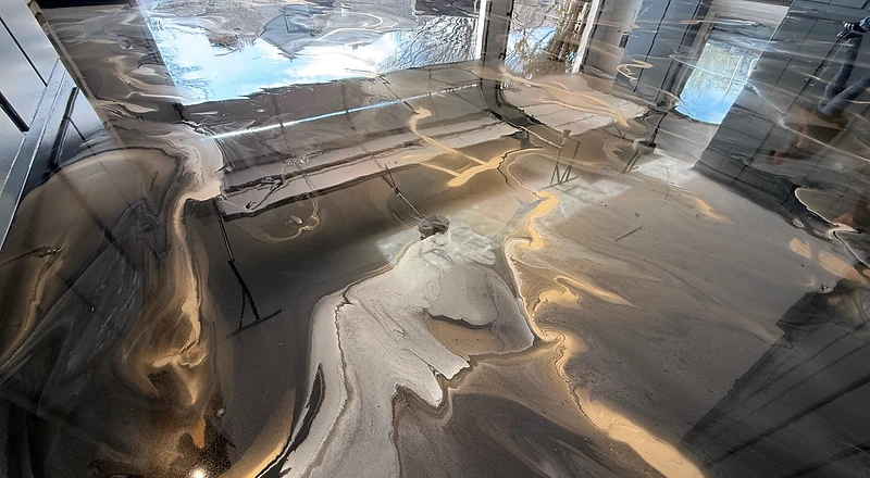Charcoal and gold metallic epoxy garage floor — finished concrete coating