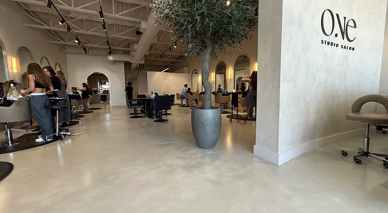 Micro cement floor installation — studio salon commercial interior