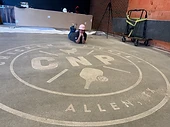 Custom etched concrete logo — Chicken Pickle brand engraved into a concrete floor