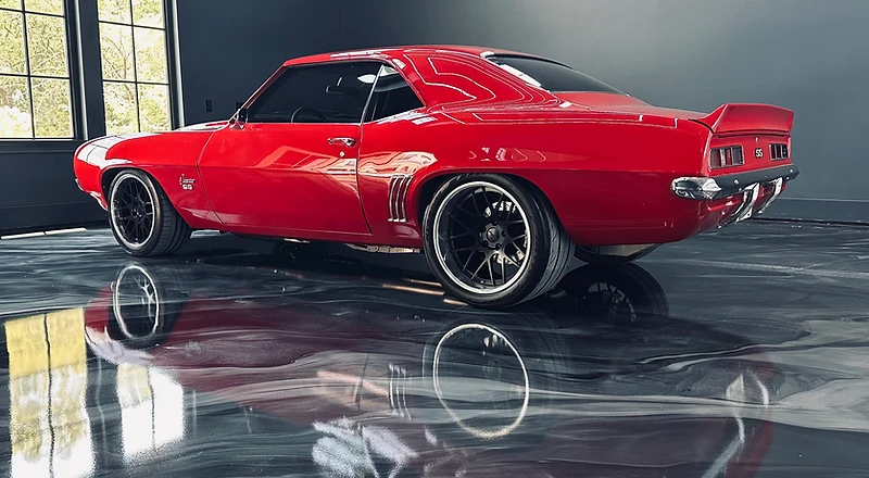Red Camaro SS on a metallic epoxy garage floor — high-gloss concrete coating