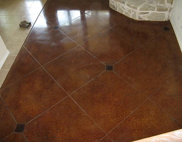 Diamond-pattern scored stained brown concrete with dark accent squares