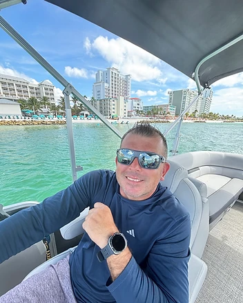 Captain Mark smiling on his pontoon boat in Clearwater Beach, Florida