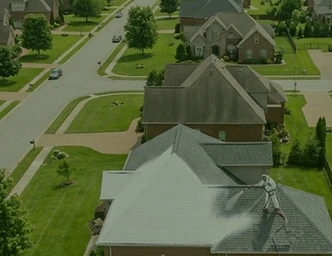 Professional applying RejuvaRoof treatment to a roof