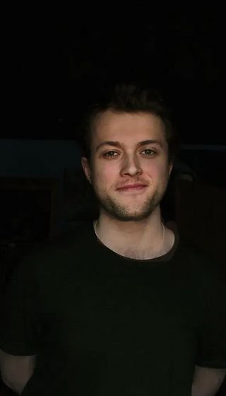 Portrait of Evan, co-founder and chef, against a dark background