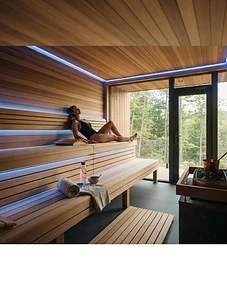 A luxurious home sauna interior with relaxing blue chromotherapy LED lighting